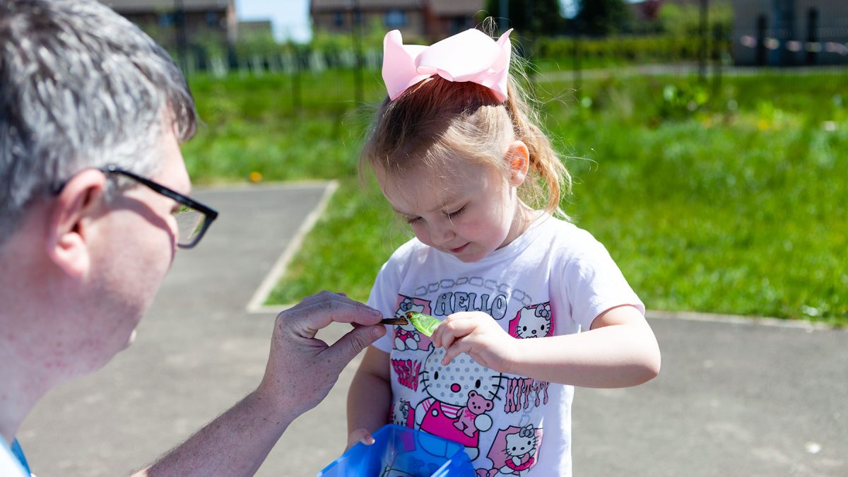 Girl looking at ladybird